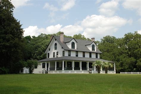 White and black house near green grass field during daytime photo ...