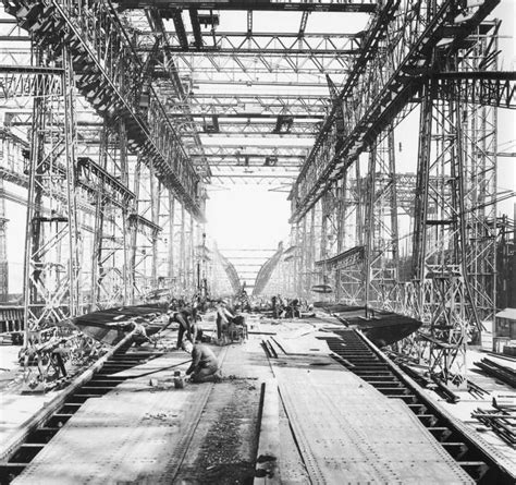 Harland and Wolff men, working beneath the Arrol Gantry, constructing the deck of Titanic's ...