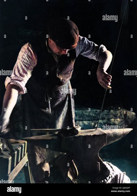 The Smithy (blacksmith) at work at his anvil in Dent, Yorkshire, England. Colourised version of ...