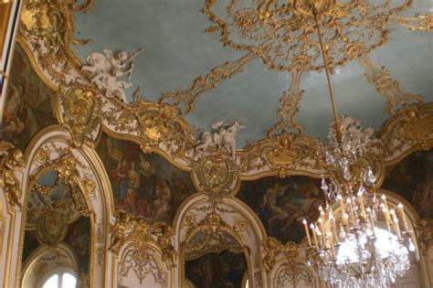 an ornately decorated room with chandeliers and paintings