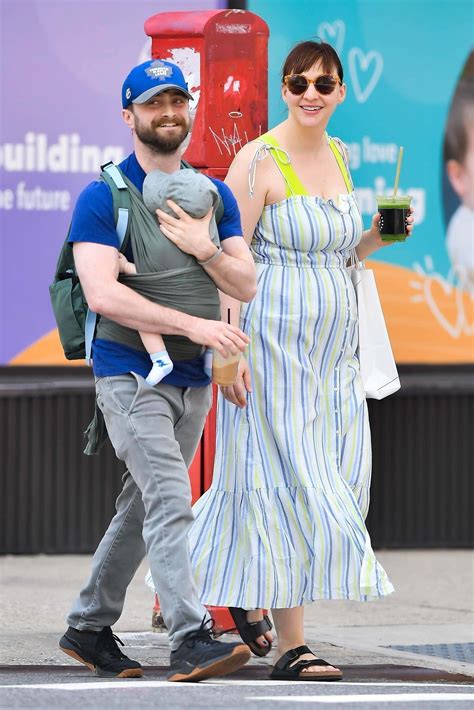 Daniel Radcliffe and Erin Darke beam with joy as they enjoy a stroll with their newborn in NYC ...