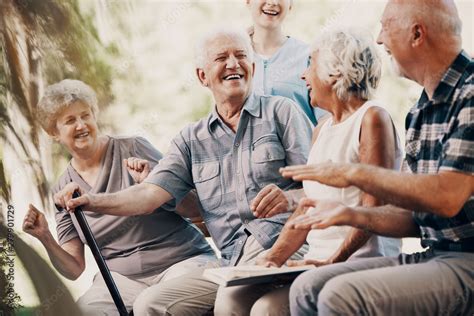 Happy elderly man with walking stick and smiling senior people relaxing ...