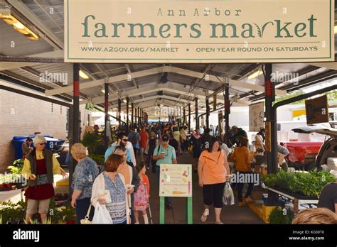 People shopping at farmers' vendor booths at year round Ann Arbor ...