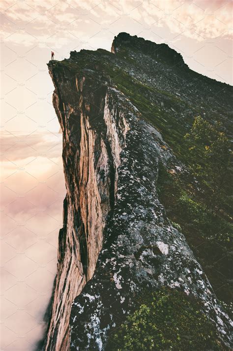 Man standing on cliff edge mountain | High-Quality Sports Stock Photos ...