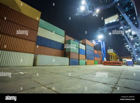 operation of container terminal at night. Unloading container ship at ...