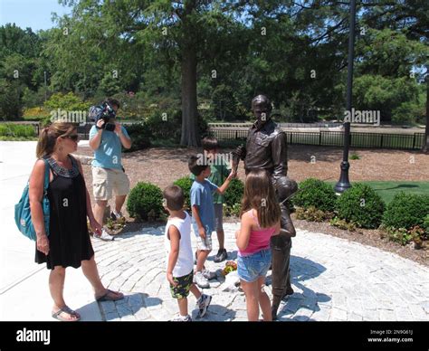 Patrice Graham and her grandchildren visit a statue of Andy Griffith at Pullen Park in Raleigh ...