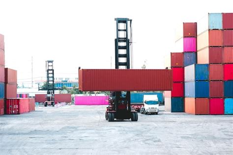 Premium Photo | Container forklift moving containers into trucks