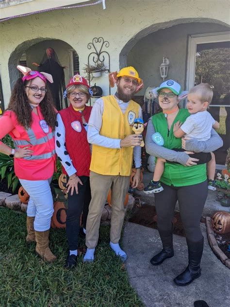 a group of people dressed up in costumes posing for a photo outside ...