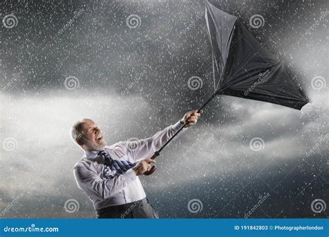 Businessman Struggling To Keep Hold of Inside-out Umbrella in Storm Stock Image - Image of ...