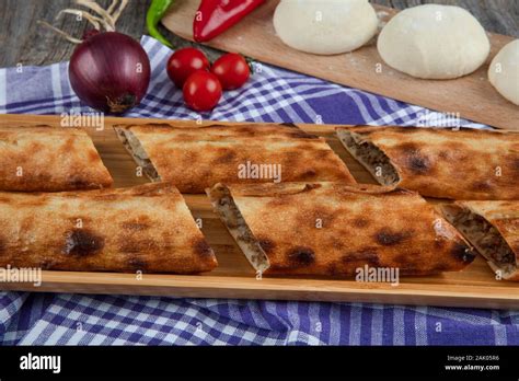 Traditional Turkish Cuisine Bafra pita (karadeniz pidesi) on rustic wood background. Bafra ...