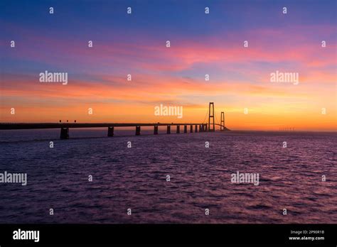 The Great Belt bridge in Denmark during a very colorful sunset Stock Photo - Alamy