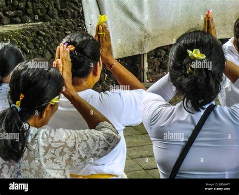 Bali Hinduism, devout people praying in front of shrine in Taman Beji Griya Waterfall, Kabupaten ...