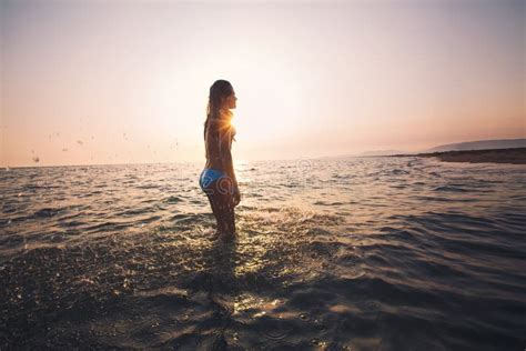 Girl on the Beach at the Sunset Time. Stock Photo - Image of jumping ...