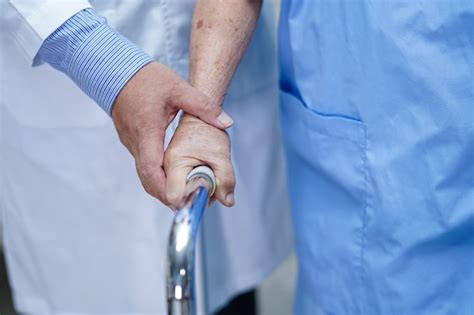 Premium Photo | Doctor help and care asian woman patient use walker in hospital