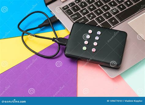 External Hard Drive Labeled Database Connected To Laptop on Bright Background. Flat Lay. the ...