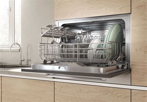 Bosch built-in compact dishwasher in a cabinet with interior view of a ...