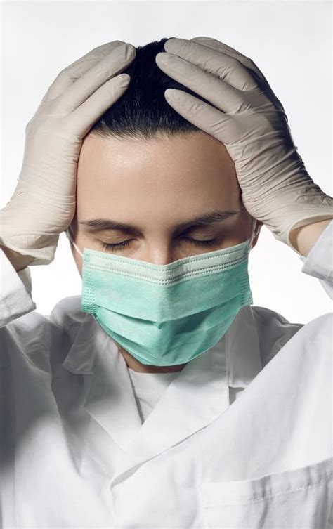 Portrait of Tired Doctor in Surgical Mask and Gloves with Closed Eyes ...