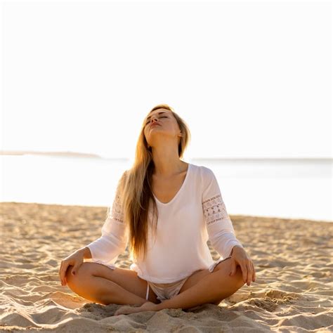 Free Photo | Woman relaxing on beach sand