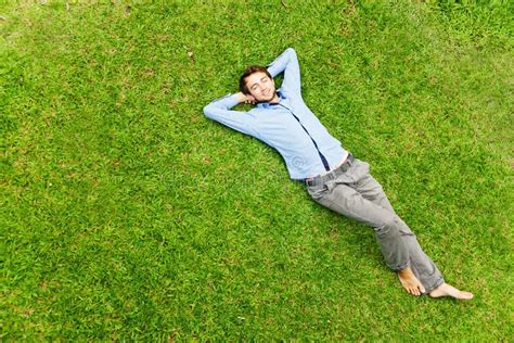 Man laying on a grass stock image. Image of freedom, natural - 61747481