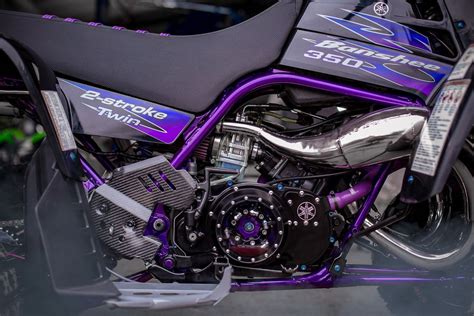 a purple and black motorcycle parked in a garage