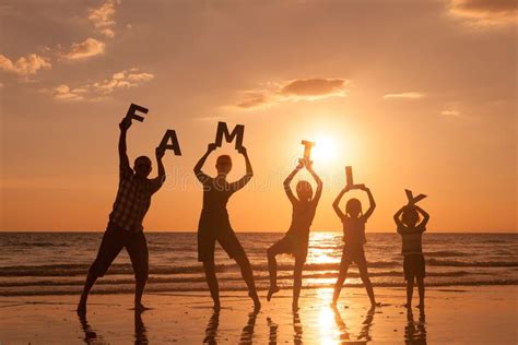 Happy Family Standing on the Beach at the Sunset Time. Stock Image - Image of brother, cheerful ...