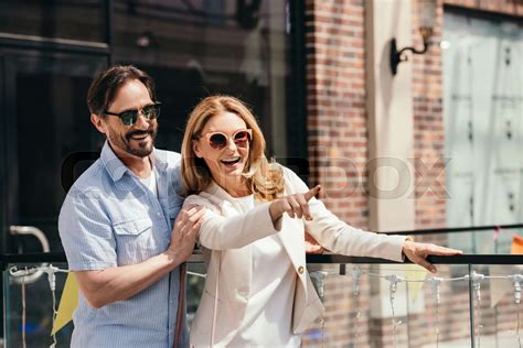 happy wife pointing on something to husband in shopping mall | Stock image | Colourbox