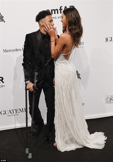 Footballer Neymar kisses his girlfriend Bruna Marquezine as he walks in ...