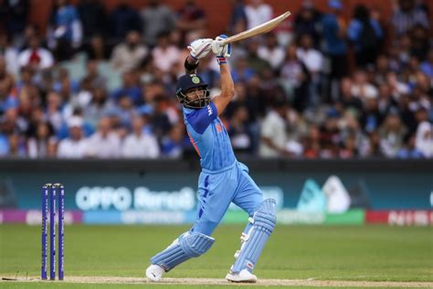 Virat Kohli holds his pose after hitting a six over cover ...