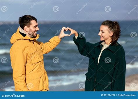 Happy Couple Making Hand Heart on Autumn Beach Stock Photo - Image of seashore, season: 231294722