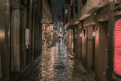 Person Walking on Concrete Alleyway at Night T · Free Stock Photo