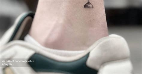 Hook tattoo located on the ankle, in memory of his