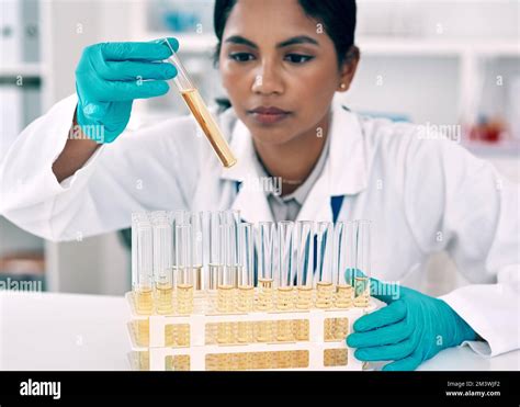 The cure might just be one experiment away. an attractive young female scientist conducting an ...