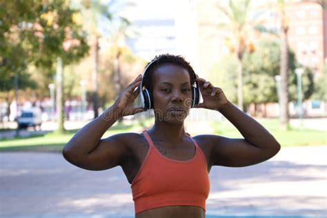 Young and Beautiful Afro American Woman with Sculpted Body Sitting in the Park before Training ...