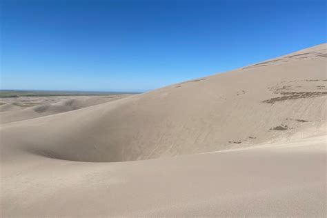 Sandboarding in Colorado (Great Sand Dunes) - Champagne Tastes®