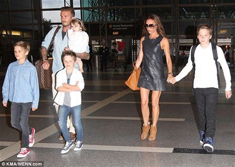 Never too old brooklyn beckham 13 holds mother victoria s hand as the family make a stylish ...