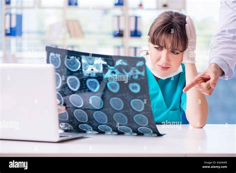 Two doctors discussing x-ray MRI image in hospital Stock Photo - Alamy