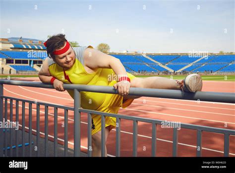 Fat funny man in sportswear doing stretching at the stadium Stock Photo - Alamy