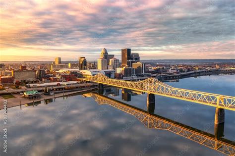 Aerial shot of the skyline of Louisville and the bridge at sunrise ...