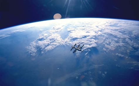 Download International Space Station (ISS) Orbiting Earth Wallpaper | Wallpapers.com