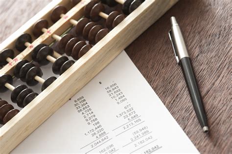 Free Stock Photo 12720 Abacus with balance sheets and pen | freeimageslive
