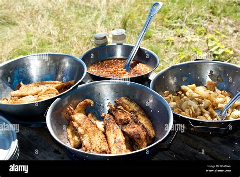 Shore lunch of baked beans deep fried walleye fillets fried potatoes with onions Stock Photo - Alamy