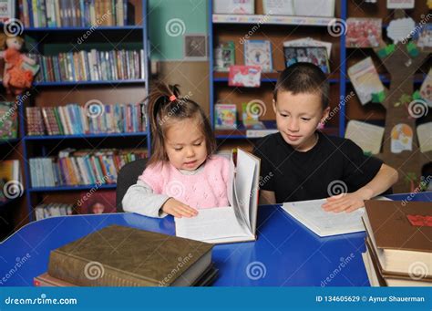 Children in Library Reading Interesting Book. Little Girl and Boy ...