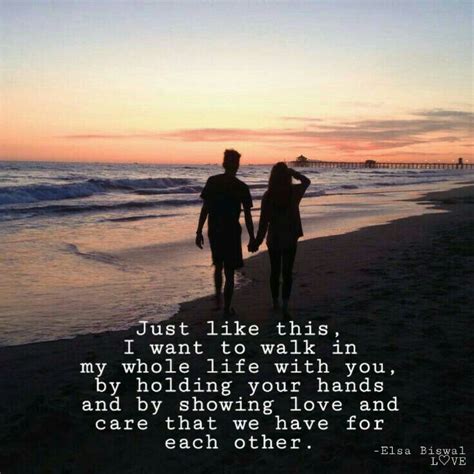 two people walking on the beach holding hands and looking at the ocean with an inspirational quote