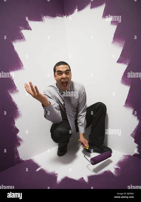 Man painting himself into a corner Stock Photo - Alamy