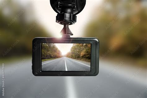 Modern dashboard camera mounted in car, view of road during driving ...