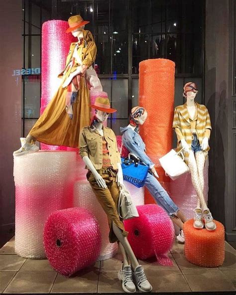 Beautiful female mannequins in a gorgeous colorful window display ...