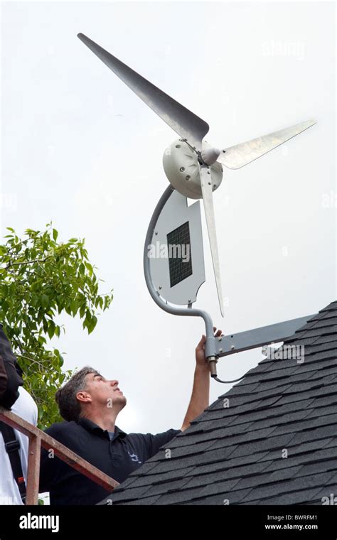 Installation of a residential wind turbine is filmed for an episode of ...