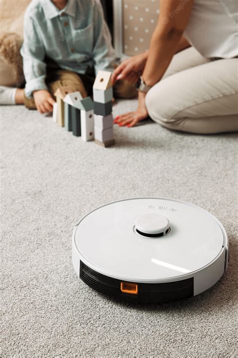 Premium Photo | Robot vacuum cleaner operates cleaning dust and particles