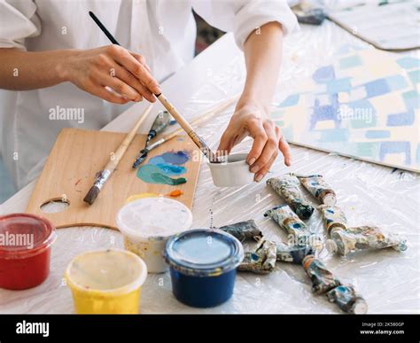 art hobby painting supplies hands mixing paint Stock Photo - Alamy