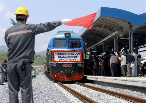 A train from North Korea arrives as a South Korean station employee ...